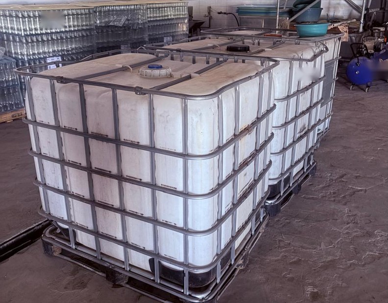 Bulk liquid containers held in a production facility